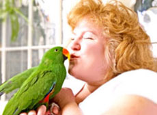 Women kissing a parrot